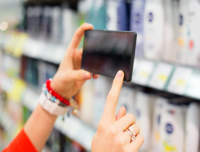 Woman taking picture in supermarket